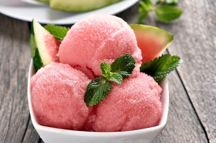 Scoops of watermelon sorbet in bowl, close up view